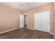 An empty bedroom featuring wood floors, light walls and a ceiling fan at 12957 W Hummingbird Ter, Peoria, AZ 85383