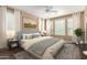 Comfortable bedroom with large windows, ceiling fan, stylish decor, and an area rug at 12957 W Hummingbird Ter, Peoria, AZ 85383