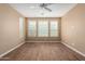 A spacious bedroom featuring wood flooring, light walls and a ceiling fan at 12957 W Hummingbird Ter, Peoria, AZ 85383