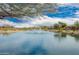 Beautiful lake with a fountain and homes in the background at 12957 W Hummingbird Ter, Peoria, AZ 85383