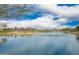 Beautiful lake with a fountain and golf course and homes in the background at 12957 W Hummingbird Ter, Peoria, AZ 85383