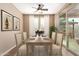 Beautiful dining room features table setting with six chairs, a sliding glass door and picturesque backyard views at 12957 W Hummingbird Ter, Peoria, AZ 85383