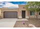 Charming single-story home with desert landscaping and a two-car garage, showcasing curb appeal at 12957 W Hummingbird Ter, Peoria, AZ 85383