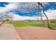 Scenic view of the golf course with lush green fairways, mature trees, and distant mountain views at 12957 W Hummingbird Ter, Peoria, AZ 85383