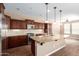 This kitchen features granite countertops, dark wood cabinets, and stainless steel appliances at 12957 W Hummingbird Ter, Peoria, AZ 85383