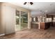 This living room has wood look floors, and a sliding glass door with access to the patio at 12957 W Hummingbird Ter, Peoria, AZ 85383