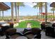 Inviting outdoor patio with comfortable seating, lush landscaping, and golf course views at 12957 W Hummingbird Ter, Peoria, AZ 85383