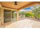 Covered patio with a ceiling fan, sliding glass door and an open view of the backyard at 12957 W Hummingbird Ter, Peoria, AZ 85383