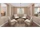 Cozy sitting room with four chairs around a coffee table; view of the office and a living room at 12957 W Hummingbird Ter, Peoria, AZ 85383