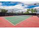 Well-maintained tennis court with nets and lighting for evening play at 12957 W Hummingbird Ter, Peoria, AZ 85383
