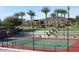 Well-maintained tennis court with nets and lighting at 12957 W Hummingbird Ter, Peoria, AZ 85383