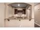 Charming wet bar area with granite countertops, wine rack and wooden cabinets offers a great place to entertain at 12957 W Hummingbird Ter, Peoria, AZ 85383