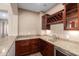 The lovely wet bar features granite counters, wooden cabinets, a wine rack, and a beverage refrigerator at 12957 W Hummingbird Ter, Peoria, AZ 85383