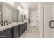 Contemporary bathroom with double vanity, sleek black fixtures, and bright lighting, offering a spa-like retreat at 13352 W Tether Trl, Peoria, AZ 85383