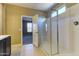 Modern bathroom with a glass-enclosed shower and a view into the bedroom at 13812 W Remuda Dr, Peoria, AZ 85383
