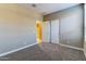 This bedroom has a closet, ensuite bathroom and plush carpet at 13812 W Remuda Dr, Peoria, AZ 85383