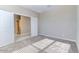 Carpeted bedroom with a glimpse into adjacent rooms through the doorway at 13812 W Remuda Dr, Peoria, AZ 85383