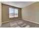 Neutral bedroom with plush carpeting, a large window, and ample natural light at 13812 W Remuda Dr, Peoria, AZ 85383