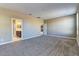 Spacious bedroom with plush carpet and a view into the bathroom and hallway at 13812 W Remuda Dr, Peoria, AZ 85383