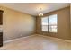 Bright dining room with tile floors, neutral walls, and a modern chandelier at 13812 W Remuda Dr, Peoria, AZ 85383