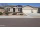 Charming single-Gathering home featuring a three-car garage and well-maintained front yard landscaping at 13812 W Remuda Dr, Peoria, AZ 85383