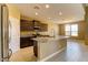 Open concept kitchen with granite counters, stainless appliances, a center island, and tile floors at 13812 W Remuda Dr, Peoria, AZ 85383