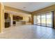 Open-concept living space featuring tile flooring that seamlessly connects the living room, dining area, and kitchen at 13812 W Remuda Dr, Peoria, AZ 85383