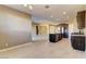 Open-concept living space with tile floors, recessed lighting, and a view into the kitchen and dining area at 13812 W Remuda Dr, Peoria, AZ 85383