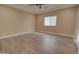 This bright bedroom boasts wood-look tile flooring, a ceiling fan, and a sliding glass door at 14161 S Palo Verde Trl, Casa Grande, AZ 85193