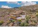 Desert home with tile roof, multi-car garage, gated entry, lush desert landscaping, and a hilltop location at 14360 E Desert Cove Ave, Scottsdale, AZ 85259
