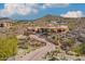 Expansive home boasts terracotta roof, desert landscape, gated entrance, and a circular layout nestled on a hillside at 14360 E Desert Cove Ave, Scottsdale, AZ 85259