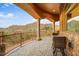Covered balcony with stone flooring and wrought iron railing overlooking scenic views at 14360 E Desert Cove Ave, Scottsdale, AZ 85259