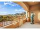Covered balcony with a statue and scenic views of the surrounding mountains and desert landscape at 14360 E Desert Cove Ave, Scottsdale, AZ 85259