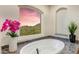 Luxurious bathroom with a soaking tub and a large window offering stunning mountain and city views at 14360 E Desert Cove Ave, Scottsdale, AZ 85259