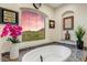 Bathroom with granite surround soaking tub featuring two arched windows and great views at 14360 E Desert Cove Ave, Scottsdale, AZ 85259