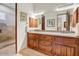 Bathroom featuring a double vanity, ample storage space, and a glass shower at 14360 E Desert Cove Ave, Scottsdale, AZ 85259