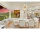 Dining area boasts mountain views, modern light fixture, and a sleek white table set for sophisticated meals at 14360 E Desert Cove Ave, Scottsdale, AZ 85259