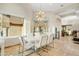 Dining area boasts mountain views, modern light fixture, and a sleek white table set for sophisticated meals at 14360 E Desert Cove Ave, Scottsdale, AZ 85259