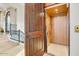 Home elevator featuring a wood paneled interior, perfect for adding convenience and accessibility at 14360 E Desert Cove Ave, Scottsdale, AZ 85259