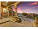 Landscaped entrance to the home features stone stairs, columns, and decorative lion statues at 14360 E Desert Cove Ave, Scottsdale, AZ 85259