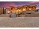 Mediterranean-style home with paved driveway, stone stairs, stucco walls, and a circular turret at 14360 E Desert Cove Ave, Scottsdale, AZ 85259
