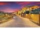 Exterior view of gated Mediterranean-style home on landscaped lot at dusk at 14360 E Desert Cove Ave, Scottsdale, AZ 85259