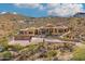 Expansive hillside home featuring a desert landscape, stone accents and clay tile roofing at 14360 E Desert Cove Ave, Scottsdale, AZ 85259