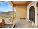 Elegant front entrance with stone columns, iron gate, and desert views at 14360 E Desert Cove Ave, Scottsdale, AZ 85259