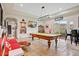 Spacious game room featuring pool table, bar area, comfortable seating and views of the backyard at 14360 E Desert Cove Ave, Scottsdale, AZ 85259