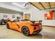 Garage featuring painted walls and ceiling, painted floor, and a sports car at 14360 E Desert Cove Ave, Scottsdale, AZ 85259