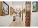 Long hallway featuring hardwood floors, framed art, recessed lighting and stylish doors at 14360 E Desert Cove Ave, Scottsdale, AZ 85259