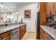 Well-equipped kitchen with stainless steel appliances, granite countertops and custom cabinetry at 14360 E Desert Cove Ave, Scottsdale, AZ 85259