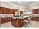 Modern kitchen with custom cabinetry, granite countertops, stainless steel appliances, and breakfast bar seating at 14360 E Desert Cove Ave, Scottsdale, AZ 85259