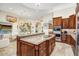 Well-appointed kitchen featuring custom cabinets, granite countertops and a large island at 14360 E Desert Cove Ave, Scottsdale, AZ 85259